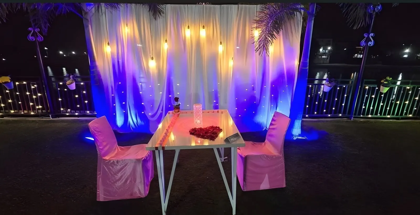 A candlelight dinner table set on the lawn