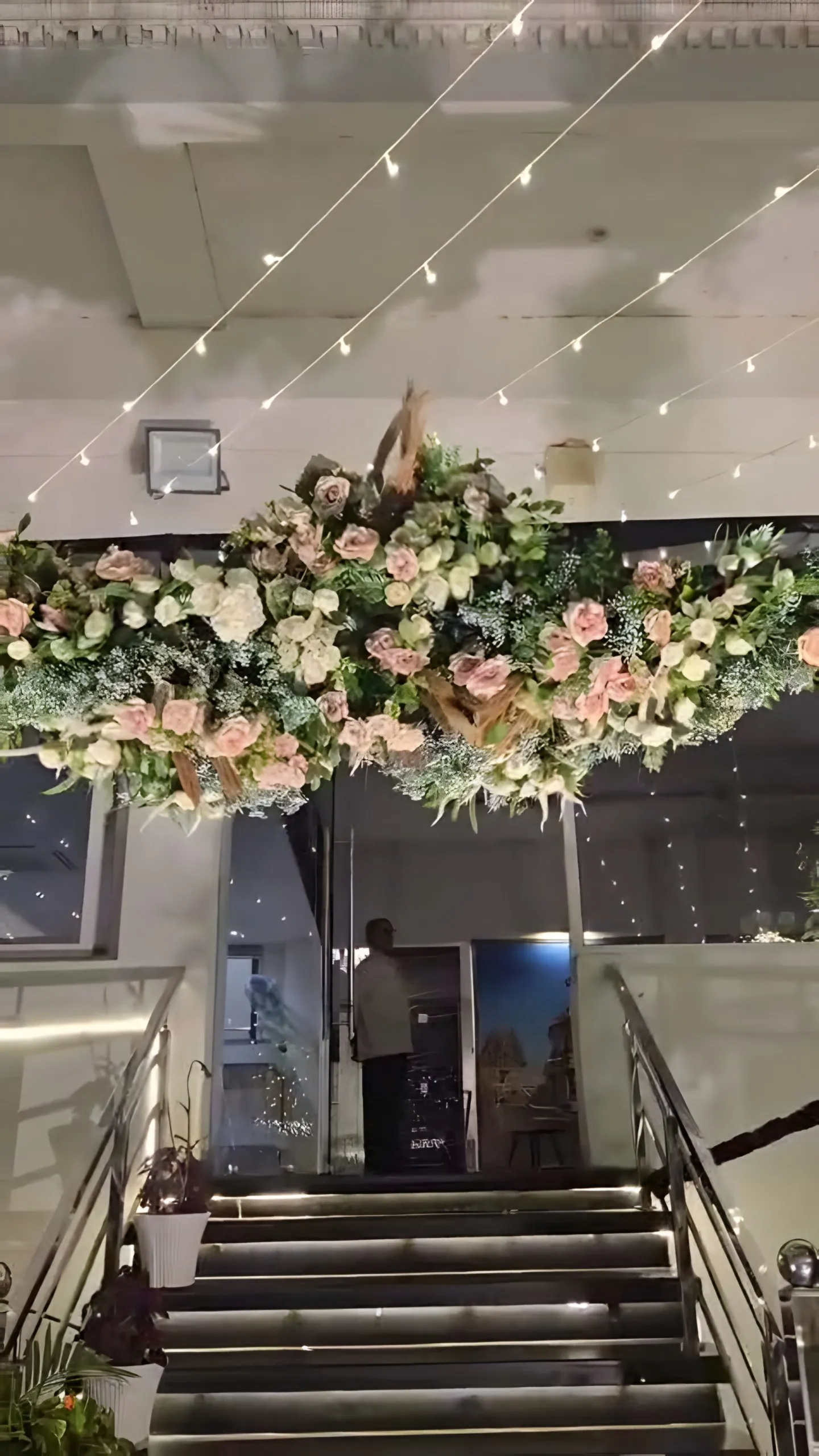 A floral arch over the hotel entrance steps