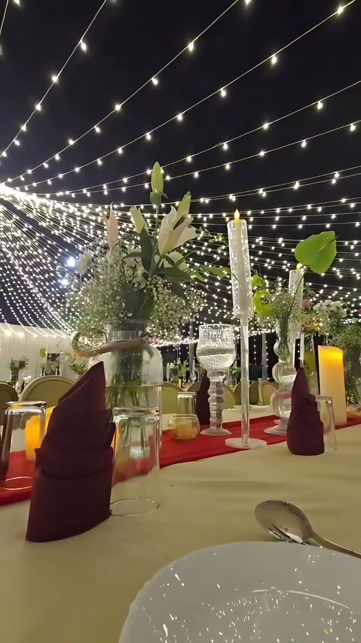 A table set with lilies under the light canopy