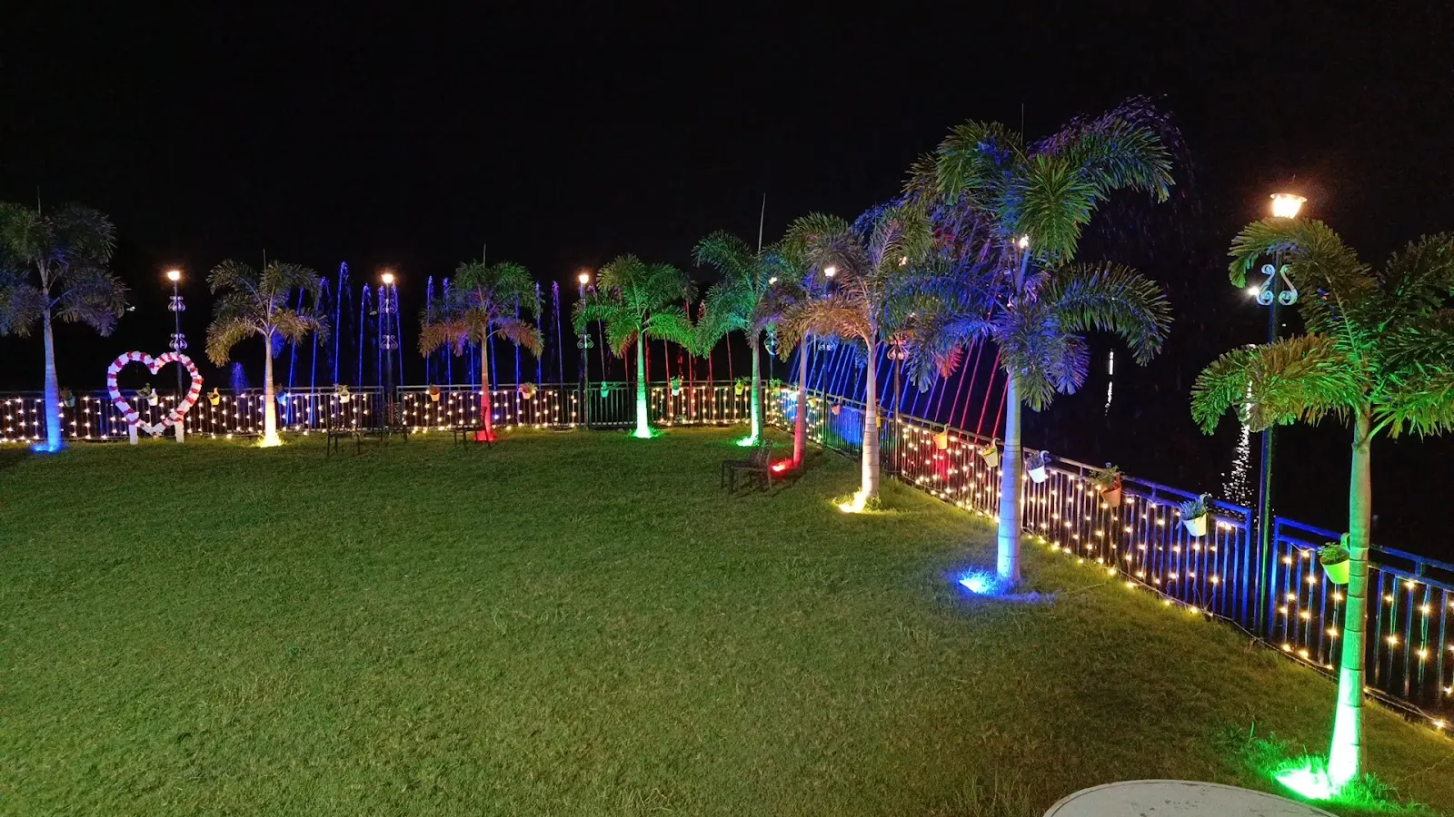 The lakeside lawn lit up at night